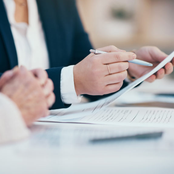 lawyer hand with pen pointing a document