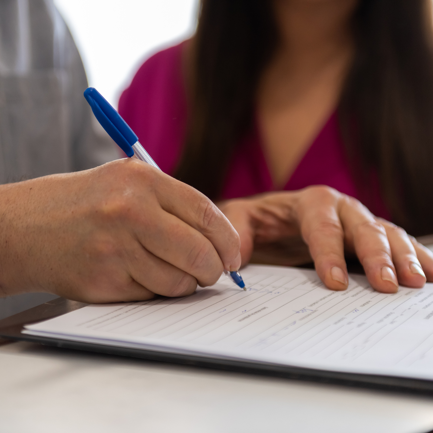 Client filling out the form with her daughter.