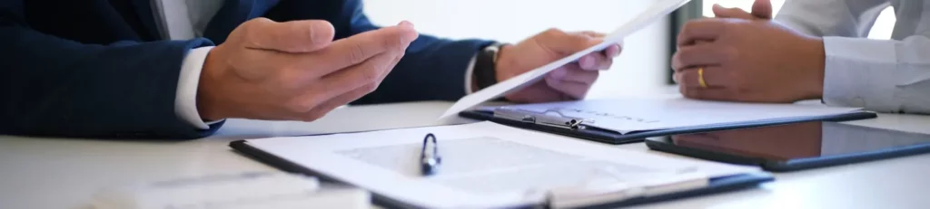 estate planning lawyer and client hands with documents